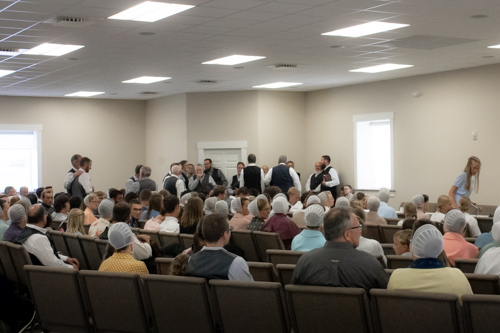 Church-goers seat themselves in a church sanctuary before the service begins.